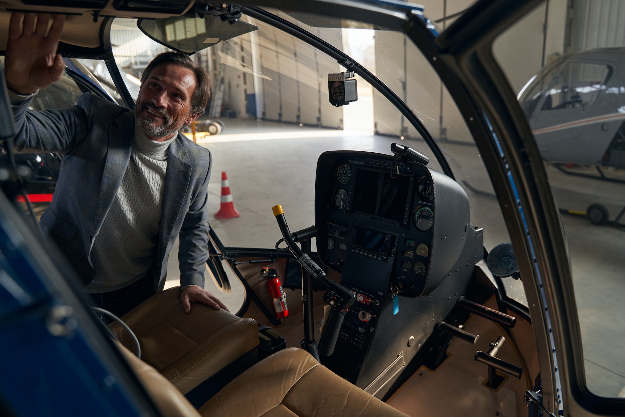 Pleased concentrated male customer selecting private helicopter